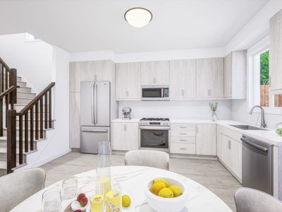 Bright modern kitchen with wood grain cabinets and stainless steel appliances